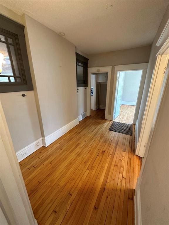 hall with light wood-type flooring