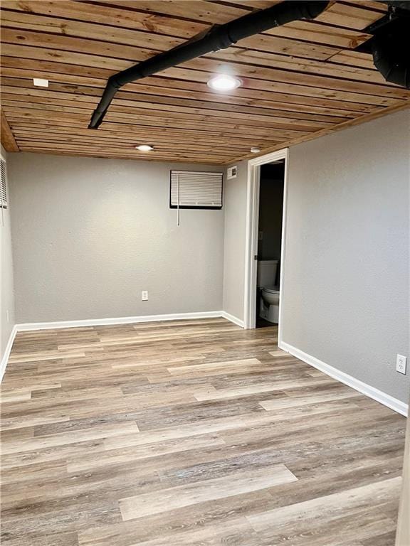 basement with light wood-type flooring and wood ceiling