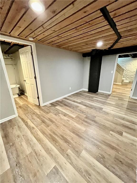 basement featuring wooden ceiling and light wood-type flooring