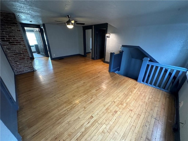 interior space with hardwood / wood-style floors and ceiling fan