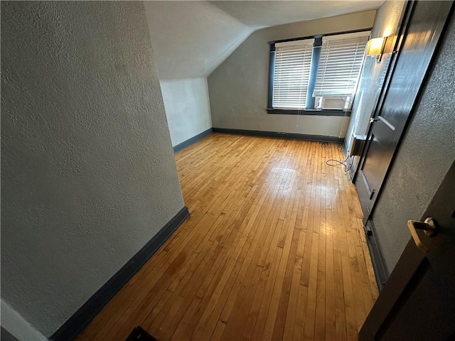 bonus room with lofted ceiling and light hardwood / wood-style flooring