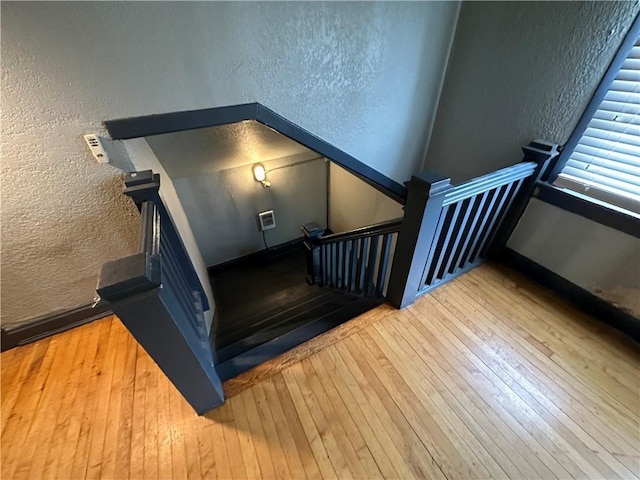 staircase featuring hardwood / wood-style flooring