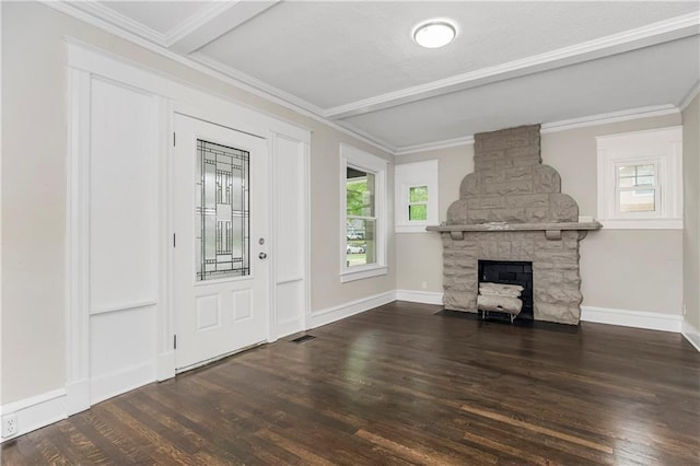 unfurnished living room featuring dark wood-type flooring, ornamental molding, a fireplace, and beamed ceiling