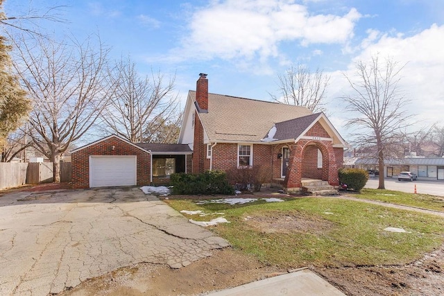 view of front of property featuring a garage and a front lawn