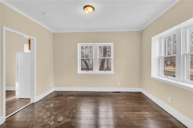 spare room with crown molding and dark hardwood / wood-style floors