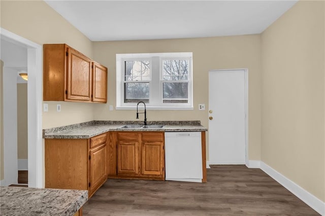 kitchen featuring sink, dark wood-type flooring, and white dishwasher