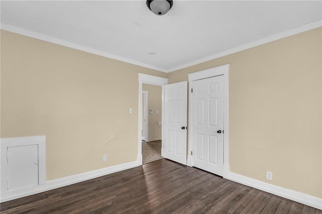 unfurnished bedroom with dark wood-type flooring and crown molding