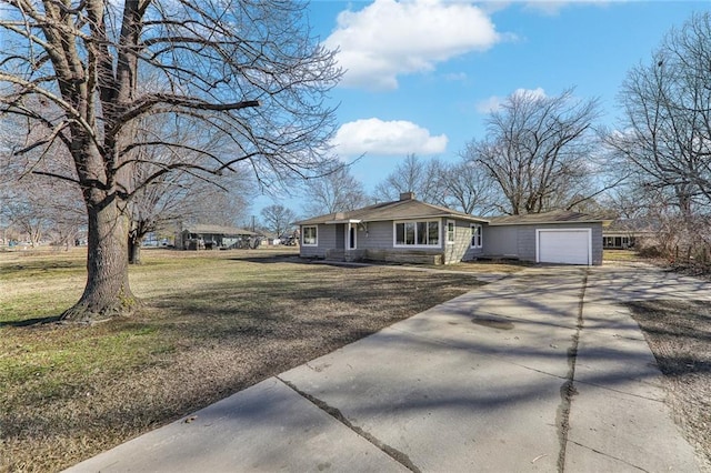 view of front of home featuring a garage, driveway, a chimney, and a front lawn