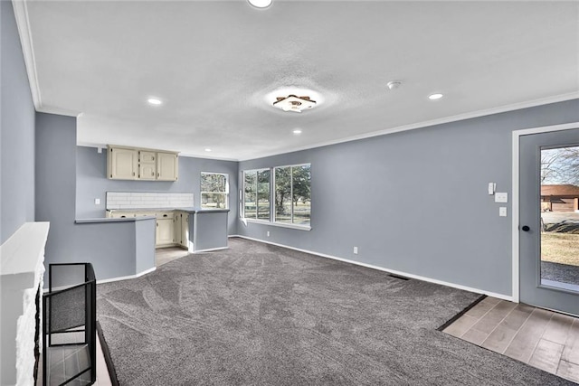 unfurnished living room featuring ornamental molding, recessed lighting, carpet floors, and baseboards