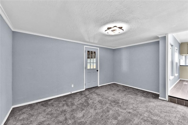 carpeted spare room featuring a textured ceiling, baseboards, and crown molding