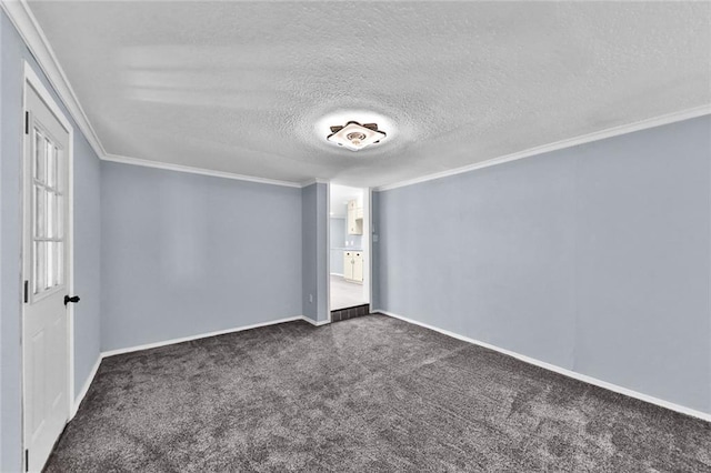 spare room featuring ornamental molding, dark carpet, a textured ceiling, and baseboards