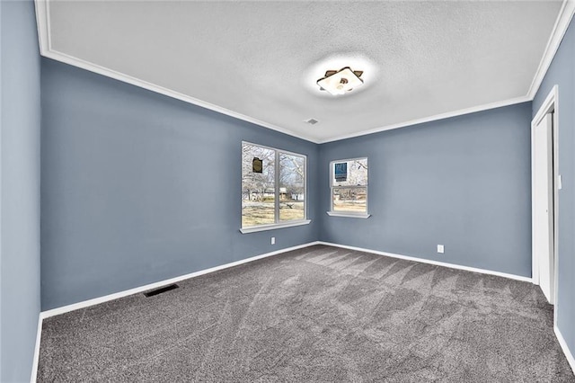 carpeted spare room featuring ornamental molding, visible vents, a textured ceiling, and baseboards