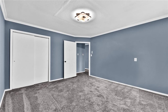 unfurnished bedroom featuring ornamental molding, a closet, carpet, and baseboards