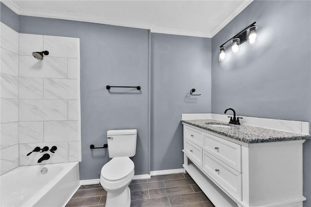 bathroom featuring crown molding, toilet, vanity,  shower combination, and baseboards