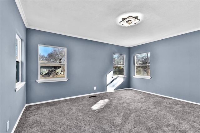 unfurnished room featuring ornamental molding, carpet, visible vents, and baseboards