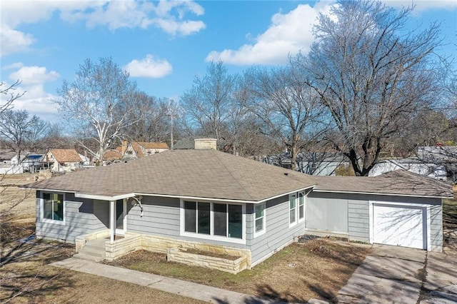 ranch-style house with driveway, a garage, a chimney, and roof with shingles