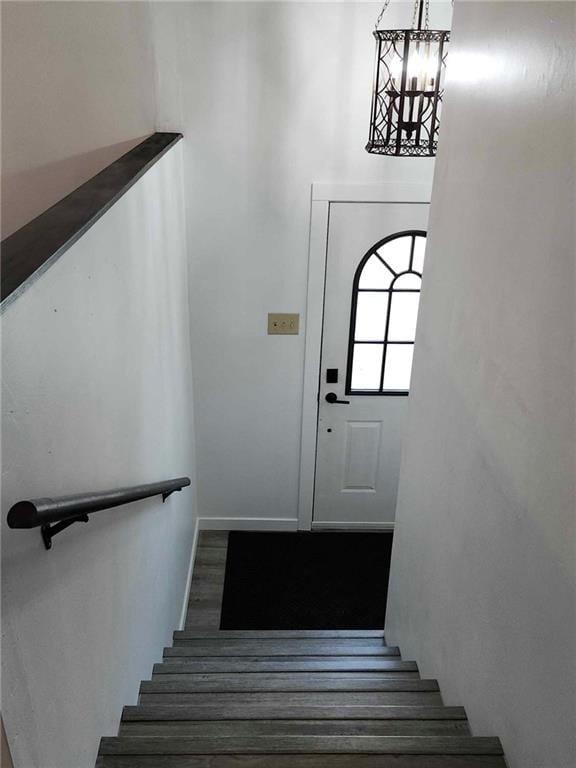 staircase featuring a notable chandelier