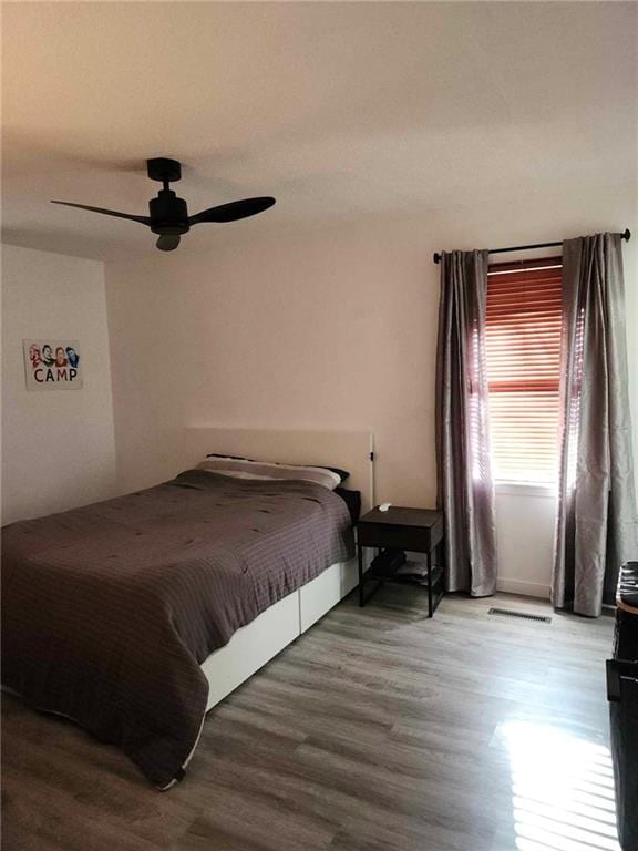 bedroom featuring wood-type flooring and ceiling fan