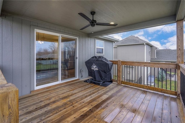 wooden deck with ceiling fan and grilling area