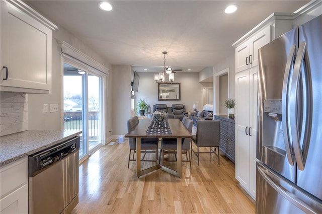 dining space featuring light hardwood / wood-style flooring and ceiling fan