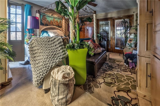 interior space with light carpet and a textured ceiling