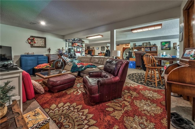 living room featuring tile patterned flooring and a textured ceiling