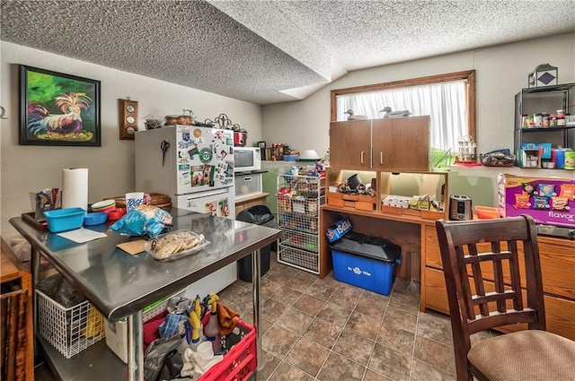 interior space with vaulted ceiling and a textured ceiling