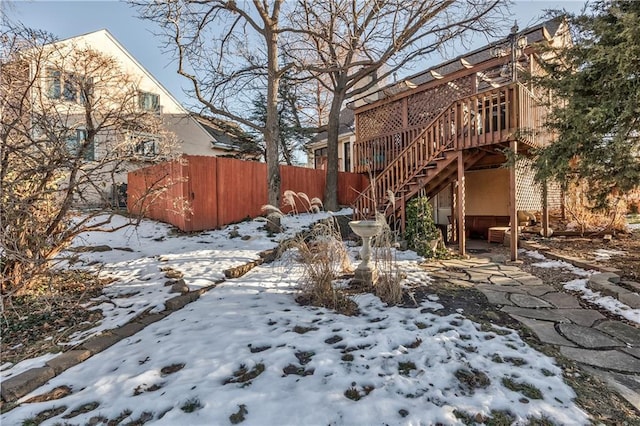 snowy yard with a wooden deck