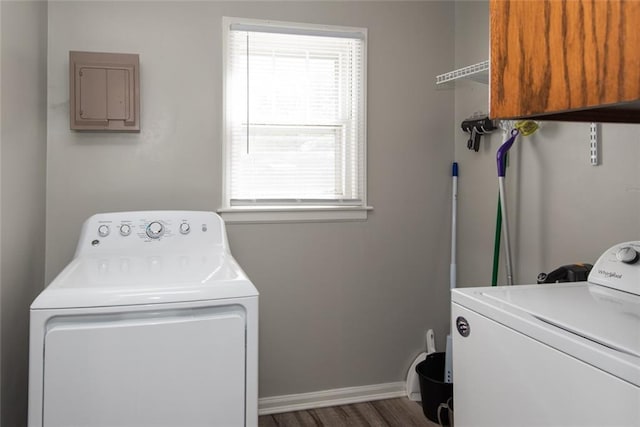 laundry room featuring dark wood-type flooring, independent washer and dryer, and a wealth of natural light