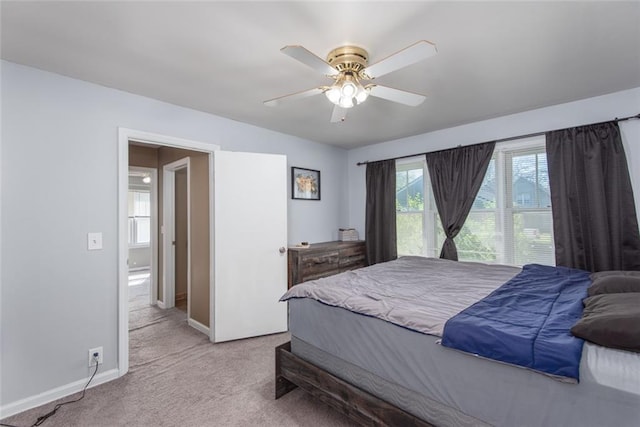 bedroom with light carpet and ceiling fan