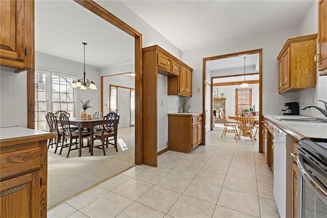 kitchen with sink, tasteful backsplash, light carpet, white dishwasher, and pendant lighting