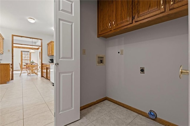 clothes washing area with washer hookup, cabinets, light tile patterned floors, and hookup for an electric dryer