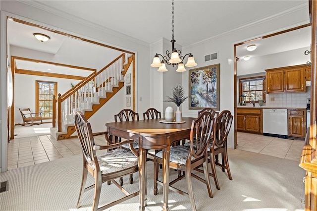 dining room featuring an inviting chandelier, light tile patterned floors, ornamental molding, and sink