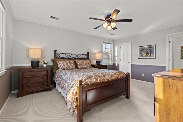 bedroom featuring ornamental molding, light colored carpet, and ceiling fan