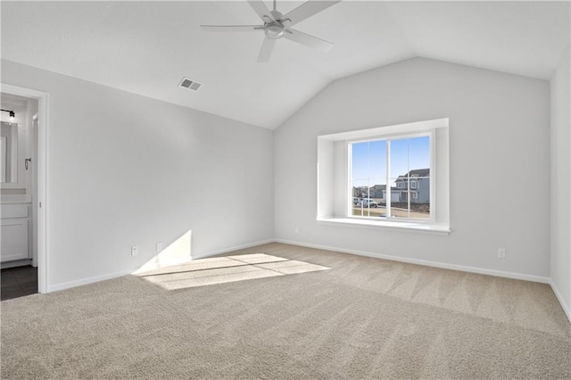 carpeted empty room with ceiling fan and lofted ceiling