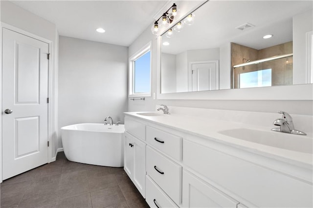 bathroom featuring independent shower and bath, vanity, and tile patterned floors