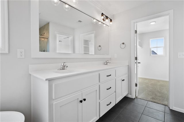 bathroom featuring vanity, a shower with door, and tile patterned flooring