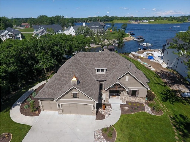 birds eye view of property with a water view