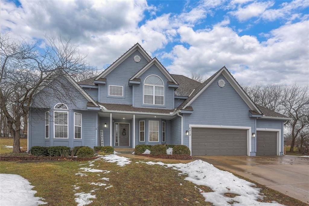 view of front of home with a garage and a front lawn