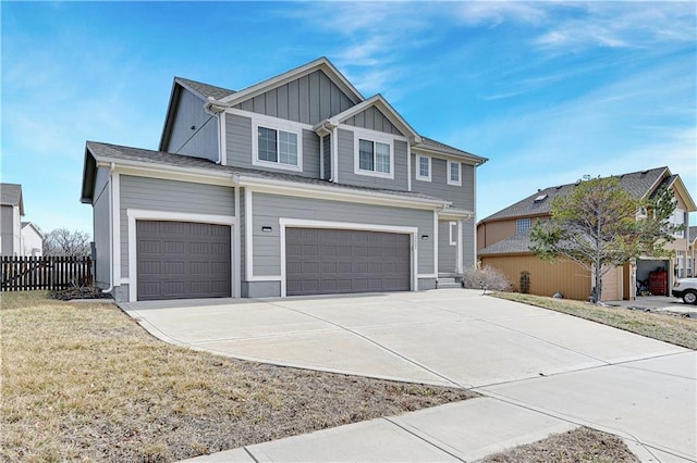 view of front facade with a garage, concrete driveway, fence, a front lawn, and board and batten siding