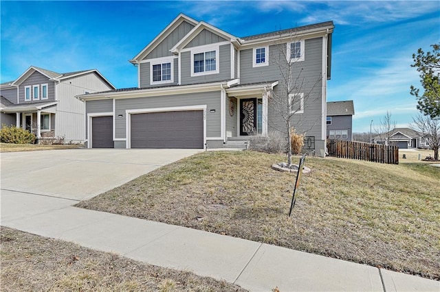 view of front of home featuring an attached garage, fence, driveway, a front lawn, and board and batten siding