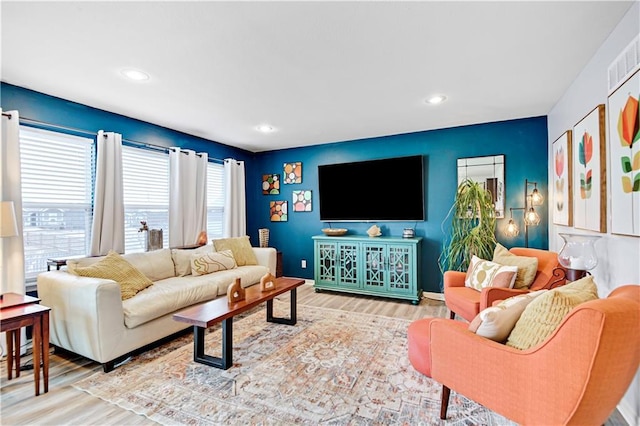 living room featuring recessed lighting, visible vents, and wood finished floors