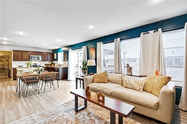 living room featuring light wood-type flooring and recessed lighting