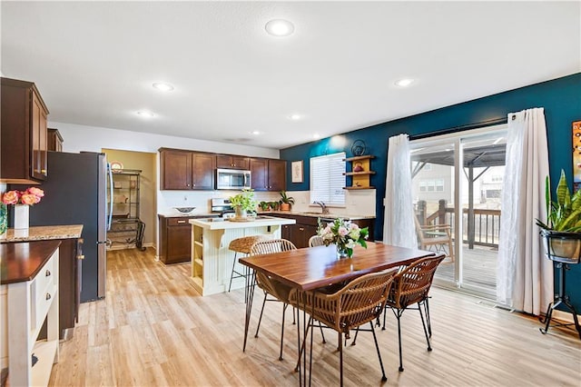 dining room featuring light wood-style floors and recessed lighting