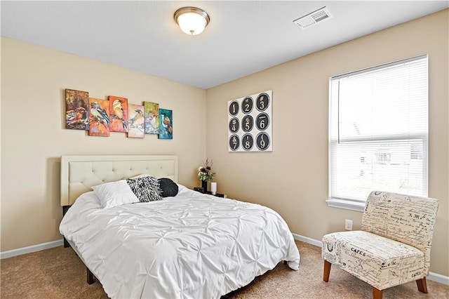 bedroom with carpet floors, baseboards, and visible vents