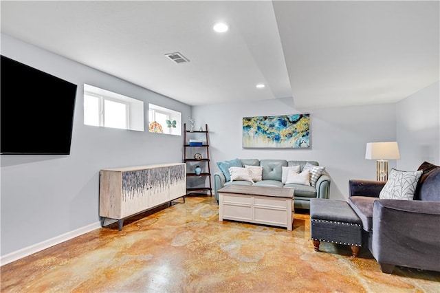 living area with finished concrete flooring, baseboards, visible vents, and recessed lighting