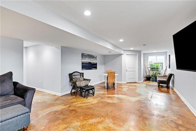 sitting room featuring recessed lighting, finished concrete flooring, and baseboards