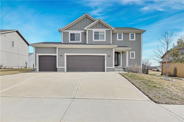 view of front of property with board and batten siding, a front yard, and driveway