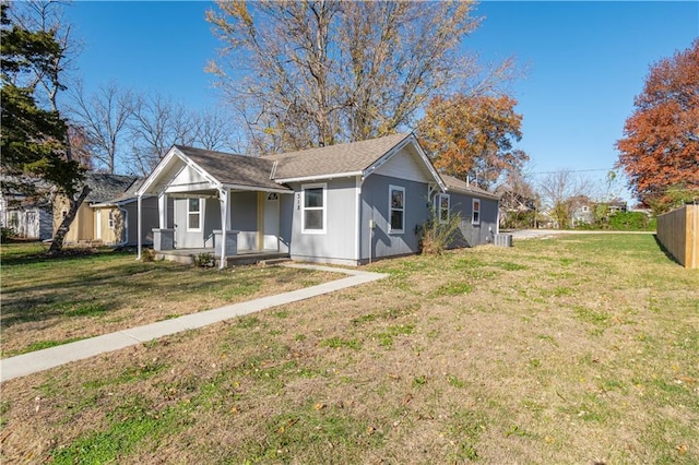 view of front of property featuring central AC, a porch, and a front lawn