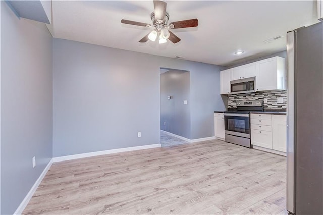 kitchen featuring white cabinetry, decorative backsplash, light hardwood / wood-style flooring, and stainless steel appliances